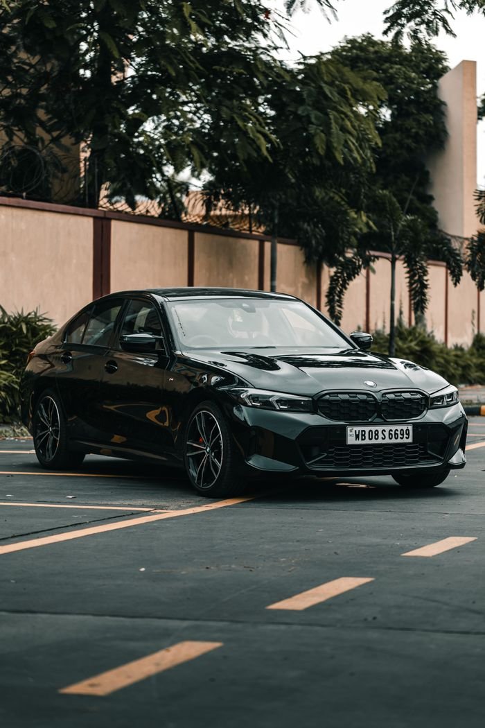 Black BMW car parked in an urban setting, showcasing luxury and style in Kolkata, India.